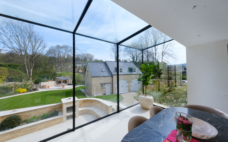 Glass roof design extending over a living space in Brook Lodge